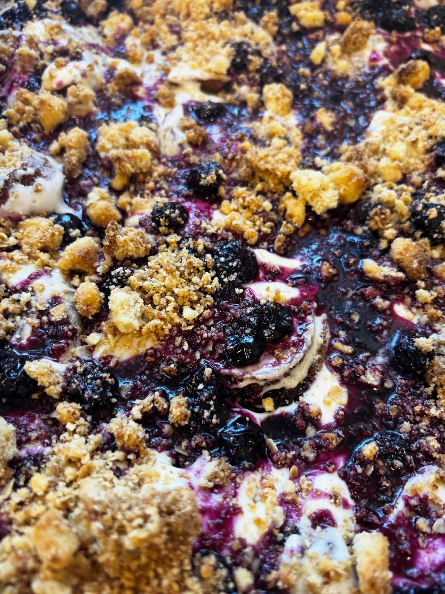 A close-up berry and crumble-topped bake
